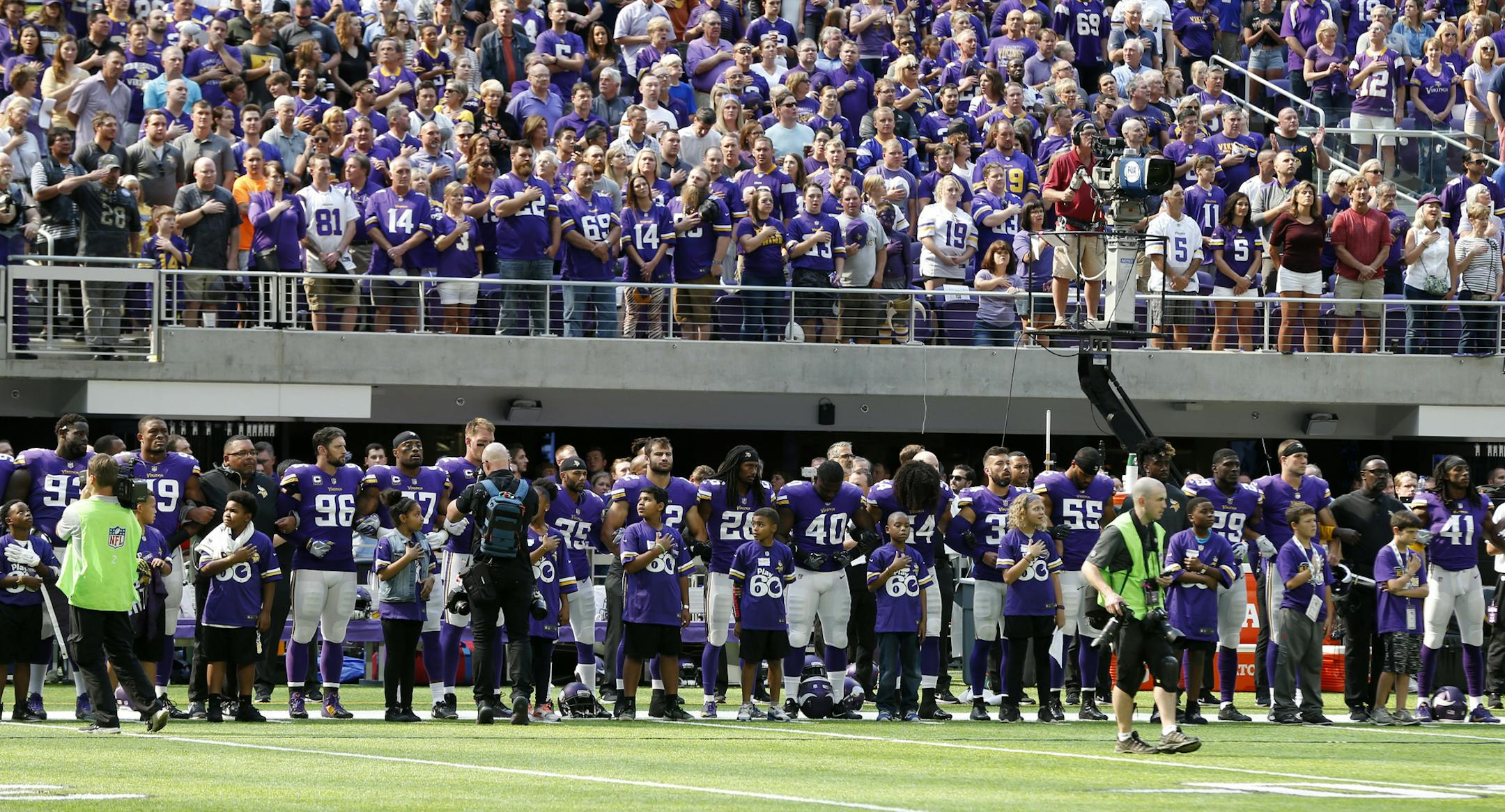 Minnesota Vikings players lock arms during the playing of the national anthem before an NFL football game against the Tampa Bay Buccaneers, Sunday, Sept. 24, 2017, in Minneapolis. (AP Photo/Jim Mone)