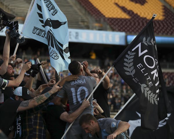 Minnesota United midfielder Miguel Ibarra (10) took a sip of hard cider while celebrating with the True North Elite and Dark Clouds fans after the Loo