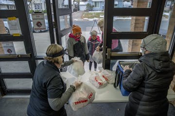 Kitchen assistants Bettie Ronning, left, and Amy Coughlin handed out school lunches to students and residents at Richfield High School on Oct. 28.