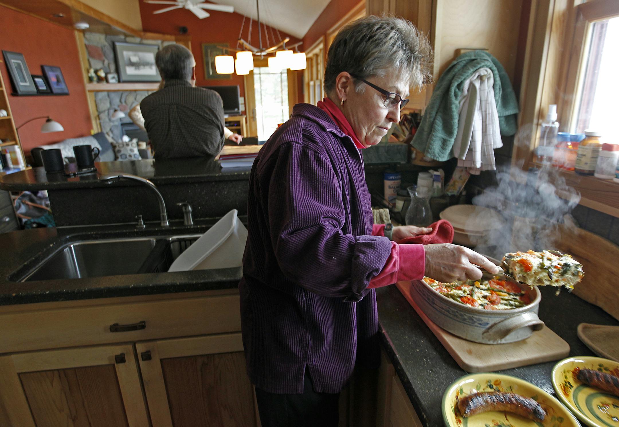 Barb Heidman prepared brunch for her husband Duane Hasegawa from their retirement home, Sunday, April 27, 2014 in Grand Marais, MN. The two built a small home along the Lake Superior shore after living in the Twin Cities. ] (ELIZABETH FLORES/STAR TRIBUNE) ELIZABETH FLORES • eflores@startribune.com
