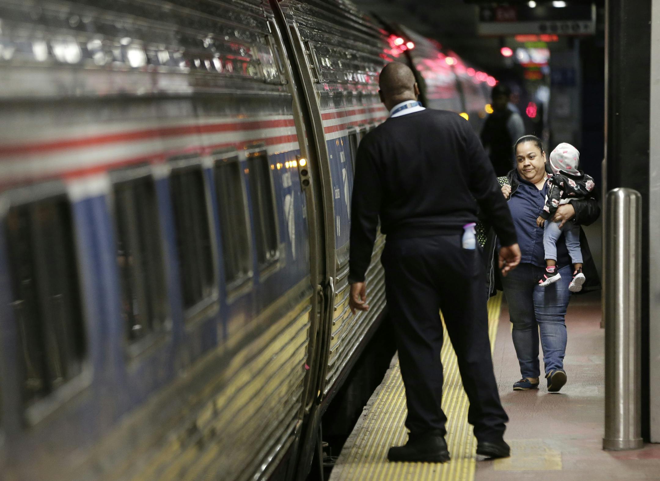 Passengers board a train in Penn Station in New York, Thursday, May 25, 2017. Recent derailments and other problems have pushed Amtrak to begin replacing aging tracks and other equipment at Penn Station, the nation's busiest rail terminal. (AP Photo/Seth Wenig)