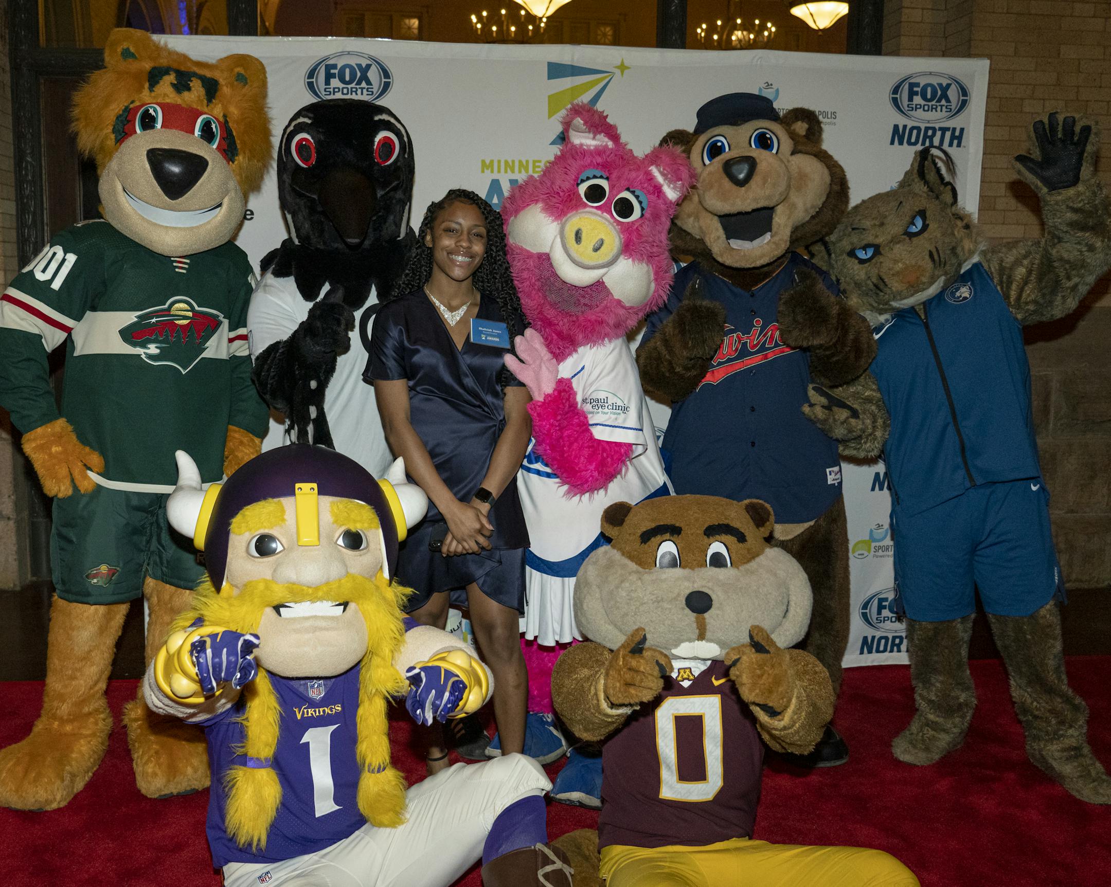 The mascotts with Shalicia Jones at the 2019 Minneapolis Sports Awards. [ Special to Star Tribune, photo by Matt Blewett, Matte B Photography, matt@mattebphoto.com, Sports Minneapolis, Minneapolis Sports Awards, The Depot, United Heroes League, Dec. 11, 2019, Minneapolis, Minnesota, 1010220591 FACE010520 Shamarah Dalton is Shaliciah's mom and gave permission. Shalicia is one of the finalists for female high school athlete of the year. https://www.minneapolis.org/sports-minneapolis/events/minneso