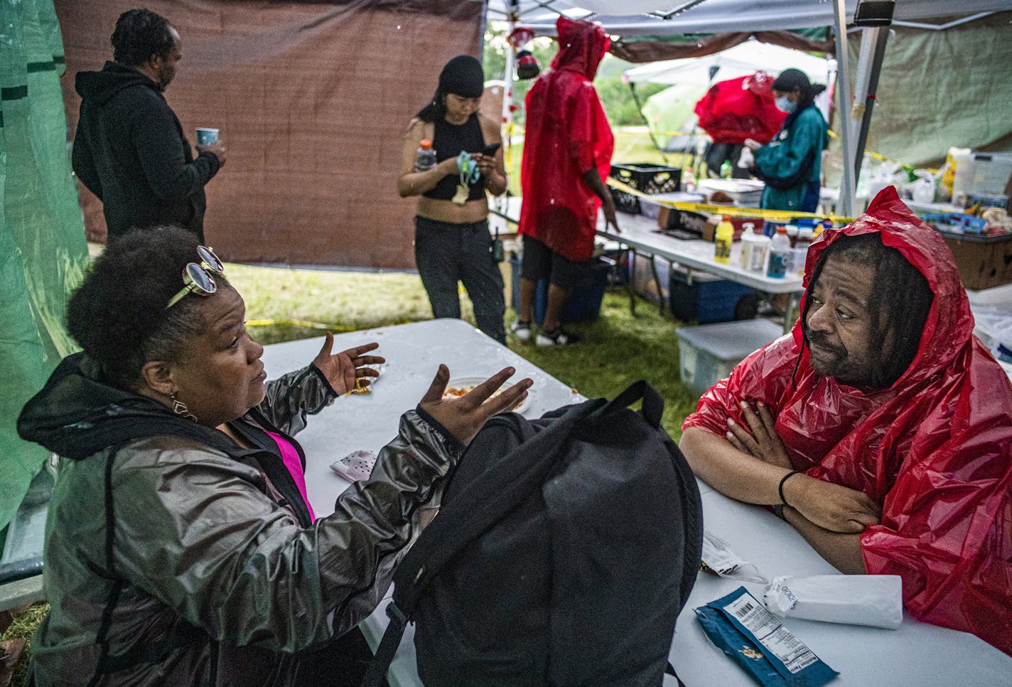 Park Board Commissioner Londel French who has been spending a lot of time at Powder Horn making sure that the encampment is a safe environment for the homeless chats with formerly homeless advocate Tyra Thomas. "Homelessness is traumatizing," she says.] RICHARD TSONG-TAATARII ¥ richard.tsong-taatarii@startribune.com