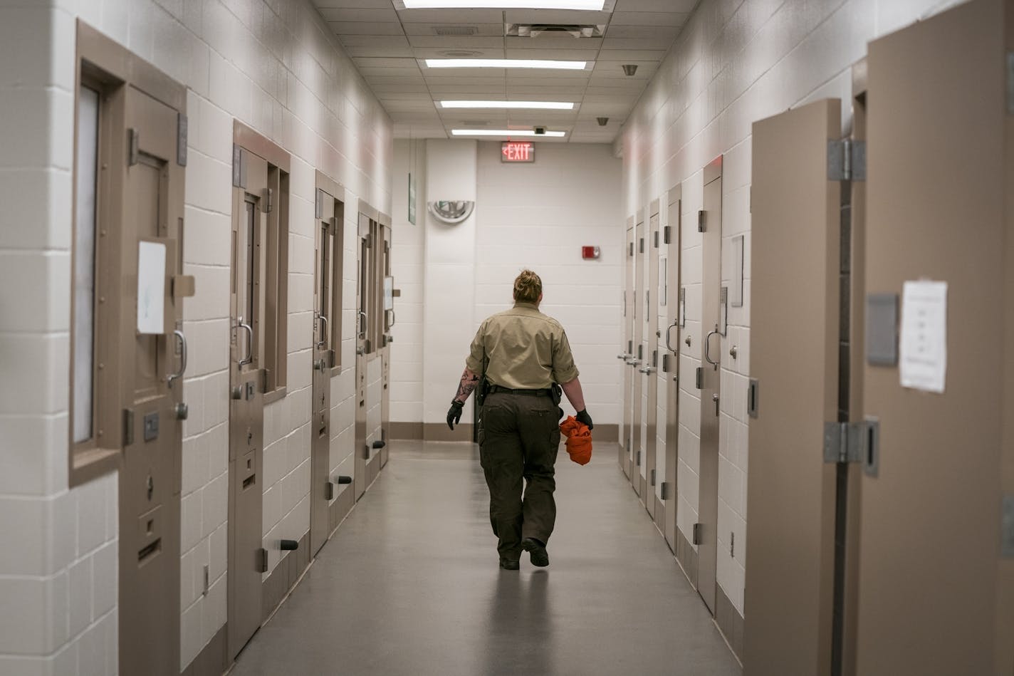 A deputy walks down the hallway of the intake area in the basement of the Hennepin County Jail.