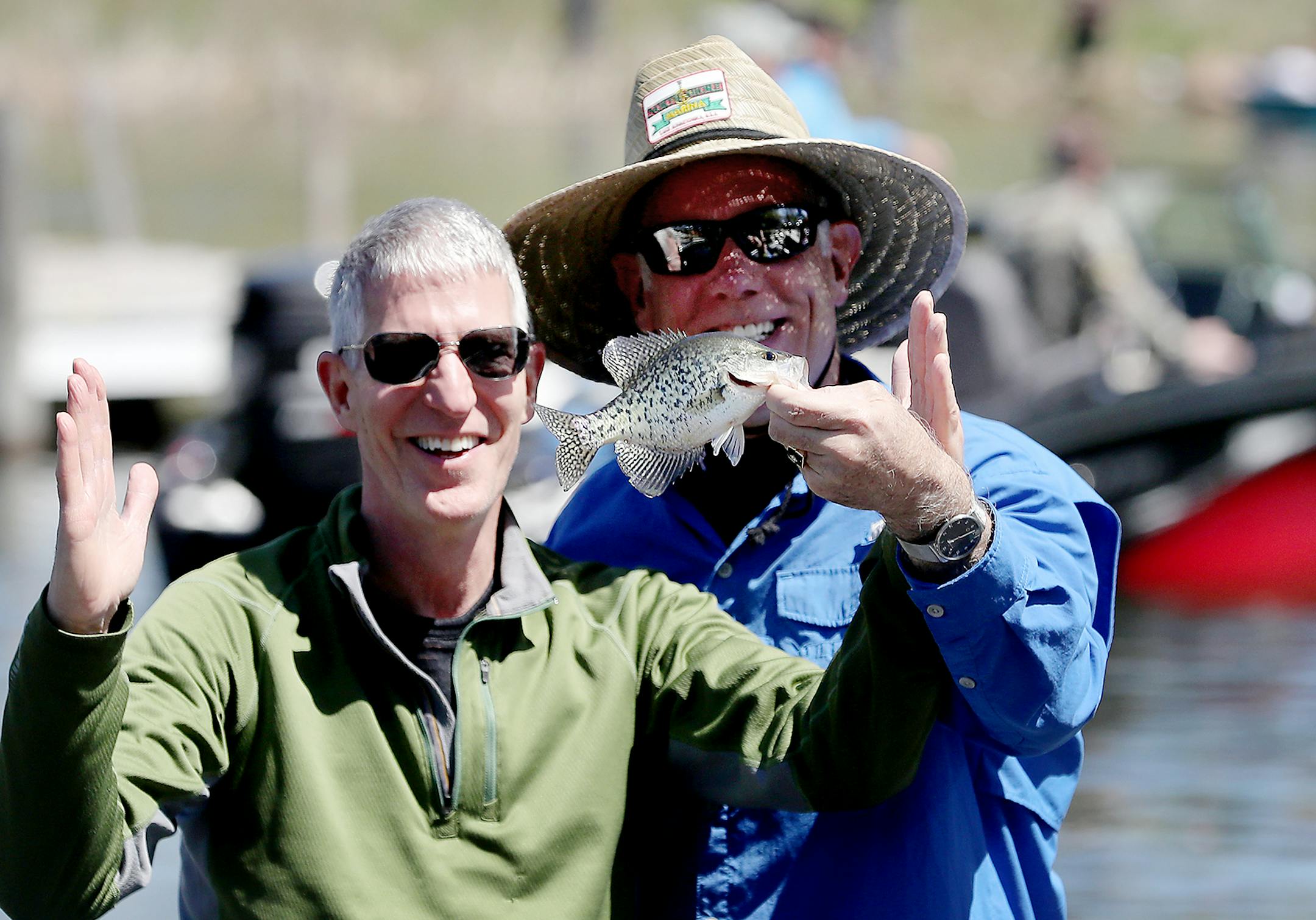 Neighbors and fishing buddies Tom Palm, right, and Jeff Twidwell, both of Orono, show off one of the about 30 crappies they caught while taking part in the Minnesota Bound Crappie Contest