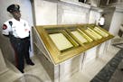 FILE - In this Sept. 16, 2003 file photo, guards stand next to the U.S. Constitution in the Rotunda of the National Archives in Washington. If there&#