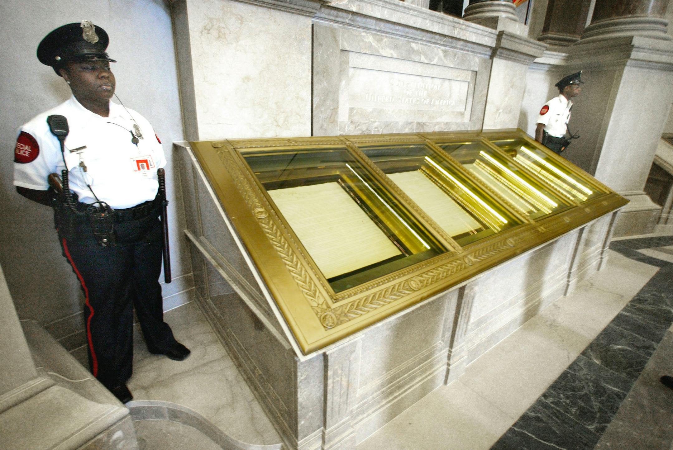 FILE - In this Sept. 16, 2003 file photo, guards stand next to the U.S. Constitution in the Rotunda of the National Archives in Washington. If thereís one thing Republicans and Democrats can agree on when it comes to guns, itís their proclaimed respect for the Second Amendment. Lawyers, scholars, judges, politicians and ordinary Americans have been puzzling over that question for much of two centuries. (AP Photo/Ron Edmonds, File)