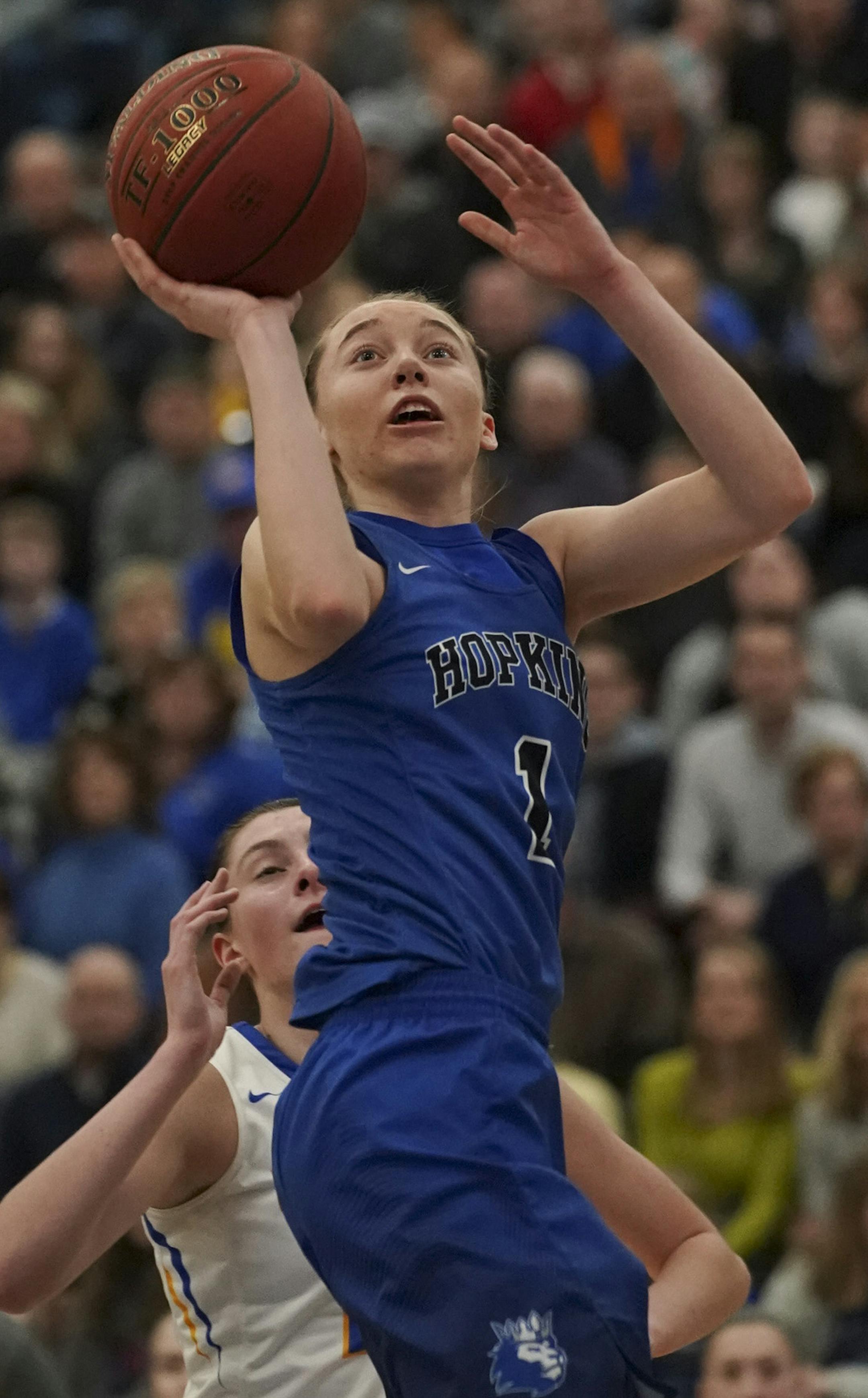 Hopkins Royals Paige Bueckers (1) for off a first half shot around the defense of Wayzata Trojans Jasmine Smiley (23). ] JEFF WHEELER &#x2022; jeff.wheeler@startribune.com Wayzata faced Hopkins in a Class 4A, section 6 girls' basketball final at Hopkins High School in Minnetonka Thursday night.
