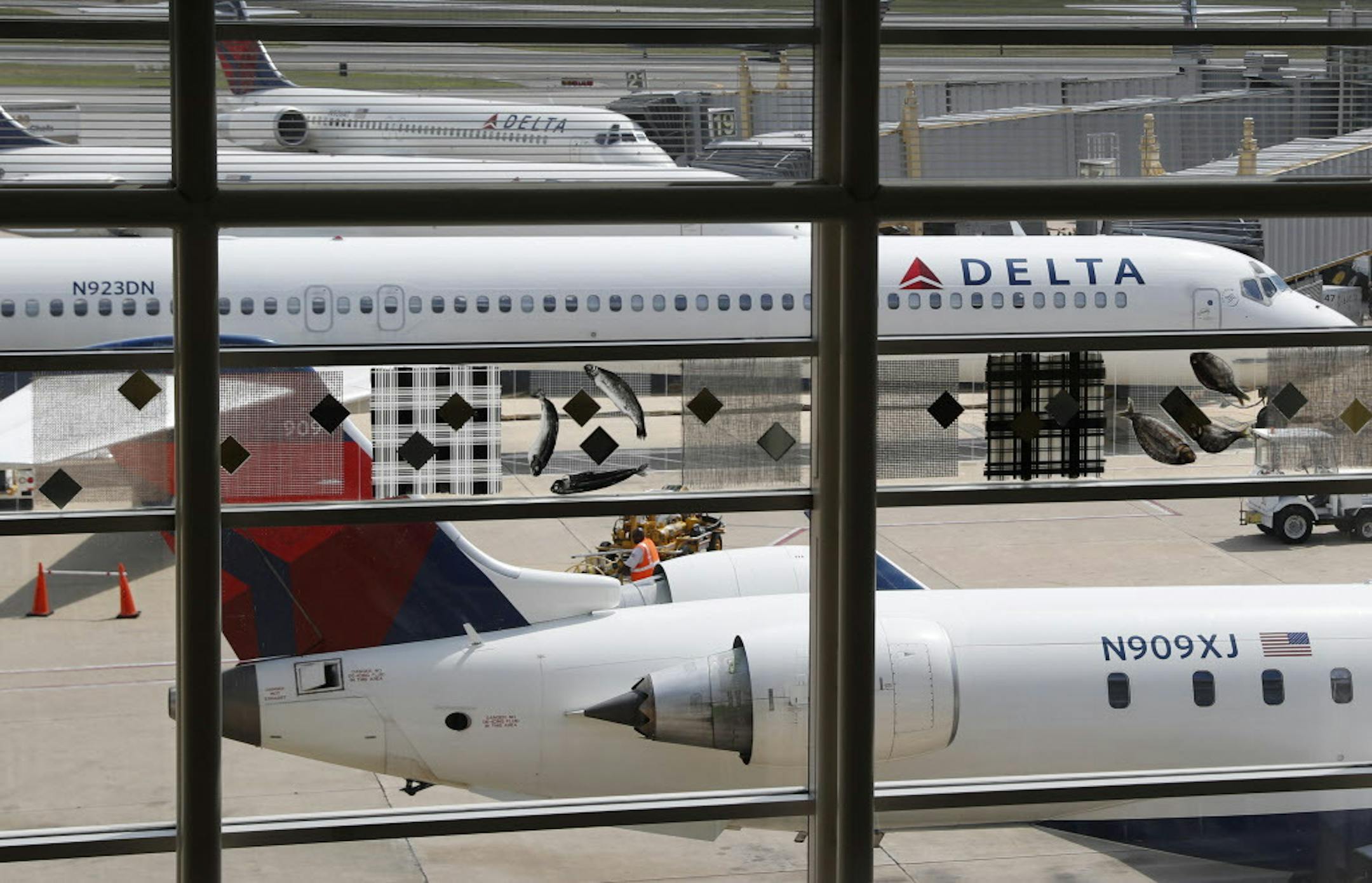 FILE - In this Monday, Aug. 8, 2016, file photo, Delta Air Lines planes are parked at Ronald Reagan Washington National Airport, in Washington. A California family says they were forced off a Delta plane and threatened with jail after refusing to give up one of their children's seats on a crowded flight. A video of the April 23, 2017, incident was uploaded to Facebook on Wednesday, May 3, 2017, and adds to the list of recent encounters on airlines that went viral, including the dragging of a pas