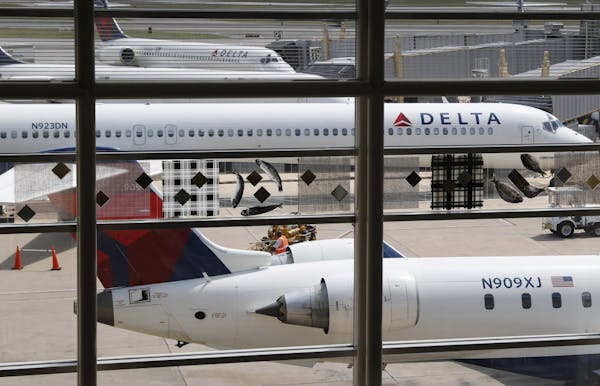 FILE - In this Monday, Aug. 8, 2016, file photo, Delta Air Lines planes are parked at Ronald Reagan Washington National Airport, in Washington. A Cali