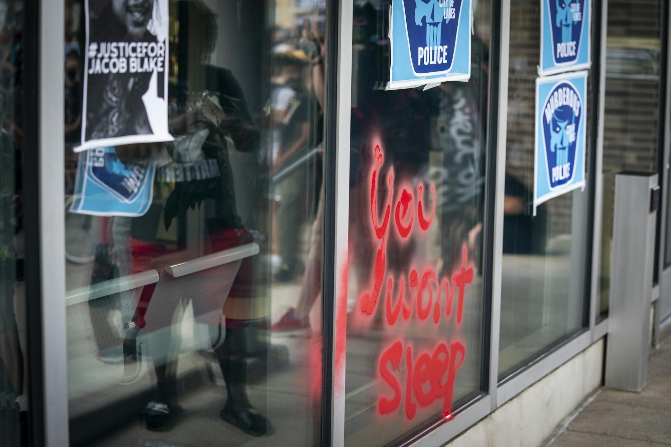 Protesters spray painted the window in front of Minneapolis Police Department's First Precinct.