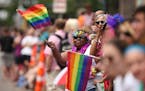 Spectators wave rainbow flags at the Pride Parade in Minneapolis in 2015.