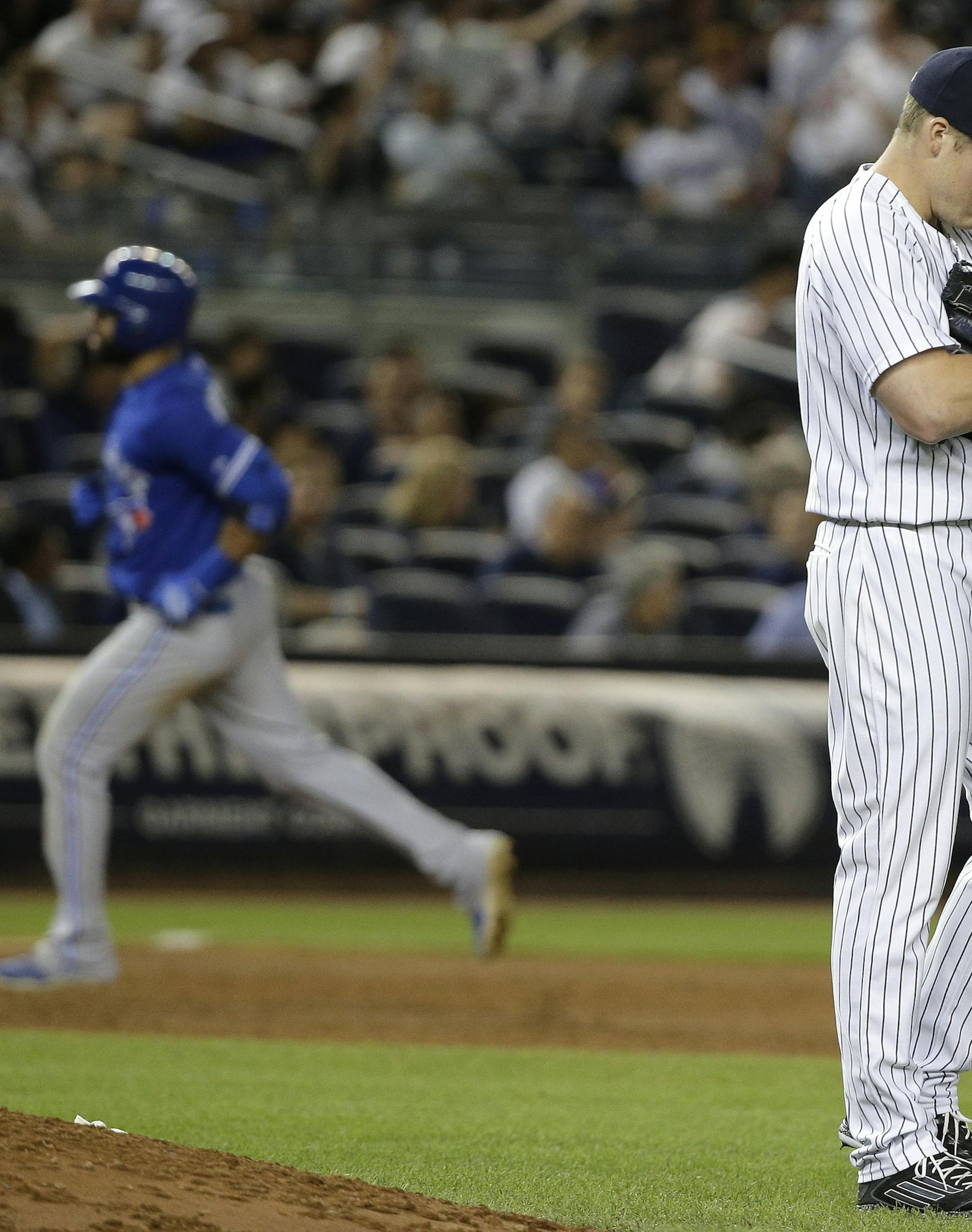 New York Yankees pitcher Branden Pinder reacts after giving up a solo home run to Toronto Blue Jays' Jose Bautista during the 10th inning of a baseball game, Friday, Aug. 7, 2015, in New York. The Blue Jays won 2-1 in 10 innings. (AP Photo/Julie Jacobson)