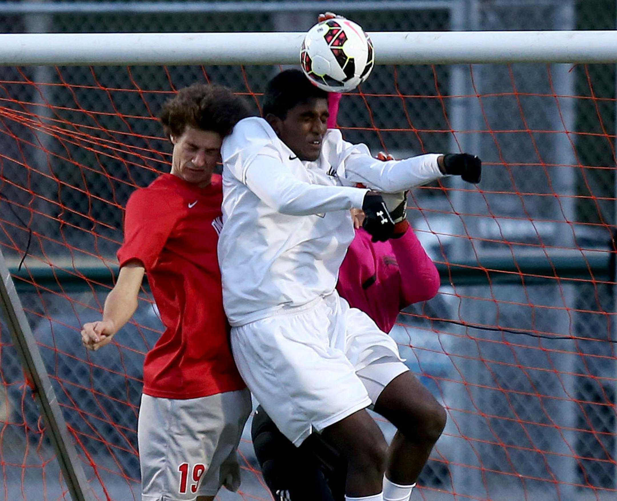 East Ridge's Ashwin Kolla and Duluth East's Bryace Holak fought for the ball after a corner kick in the first half. ] (KYNDELL HARKNESS/STAR TRIBUNE) kyndell.harkness@startribune.com Class 2A boys' soccer quarterfinals. Duluth East vs. East Ridge Chisago Lakes High School in Lindstrom Min., Wednesday, October 22, 2014. East Ridge won over Duluth East 1-0.
