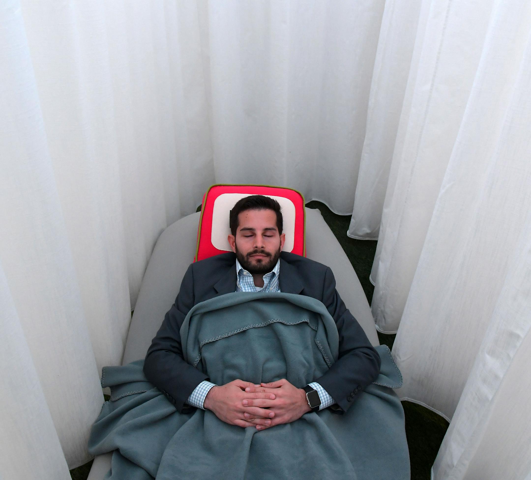 Daniel Turissini relaxes in one of Recharj's napping cocoons in Washington, D.C. MUST CREDIT: Washington Post photo by Katherine Frey