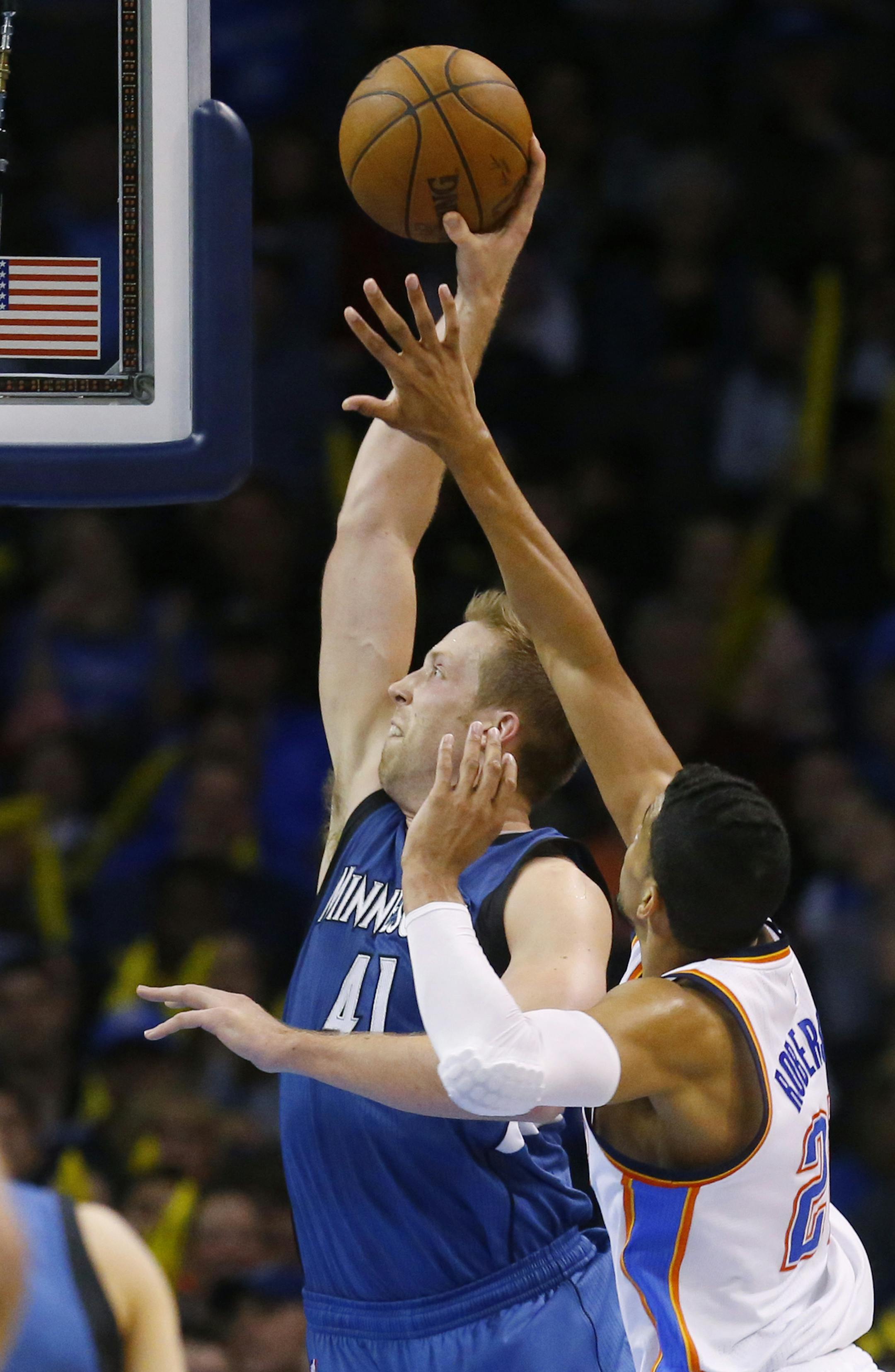 Minnesota Timberwolves center Justin Hamilton (41) shoots in front of Oklahoma City Thunder guard Andre Roberson (21) during the third quarter of an NBA basketball game in Oklahoma City, Friday, March 13, 2015. Oklahoma City won 113-99. (AP Photo/Sue Ogrocki)