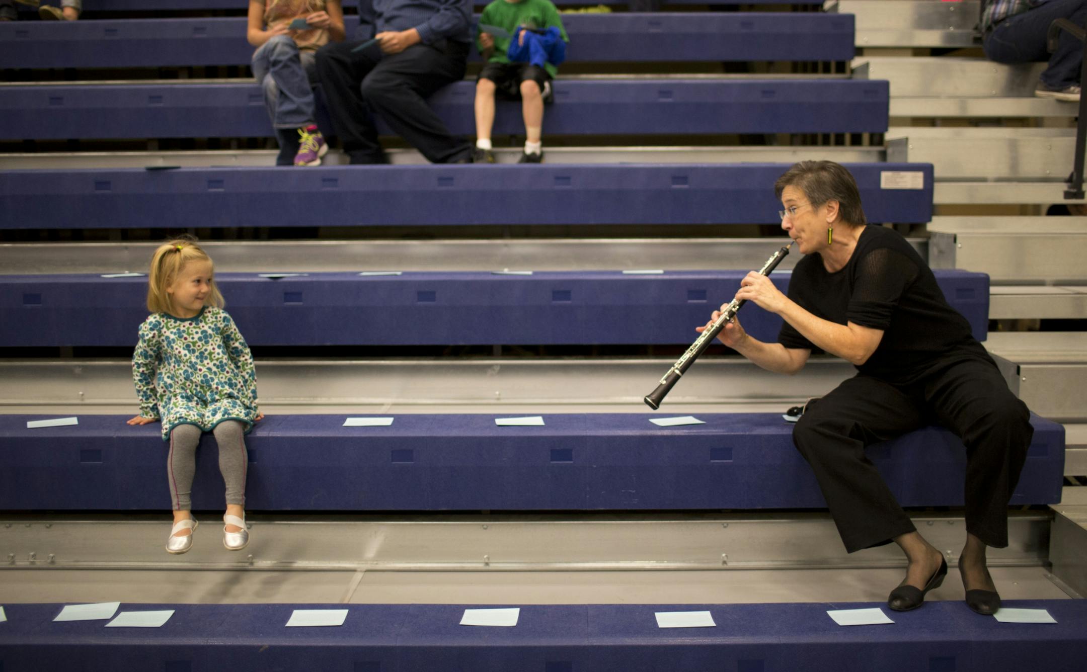 The musicians of the St. Paul Chamber Orchestra, entrenched in contract talks with management, were looking to drum up public support by presenting a free concert Tuesday night, October 2, 2012 in the Leonard Center Gymnasium on the Macalester College campus in St. Paul, Minn. SPCO oboist Kathy Greenbank played a few bars of Mary Had a Little Lamb for Madeleine Klevay, 4, who came near her to listen to her warmup before the performance Tuesday night.