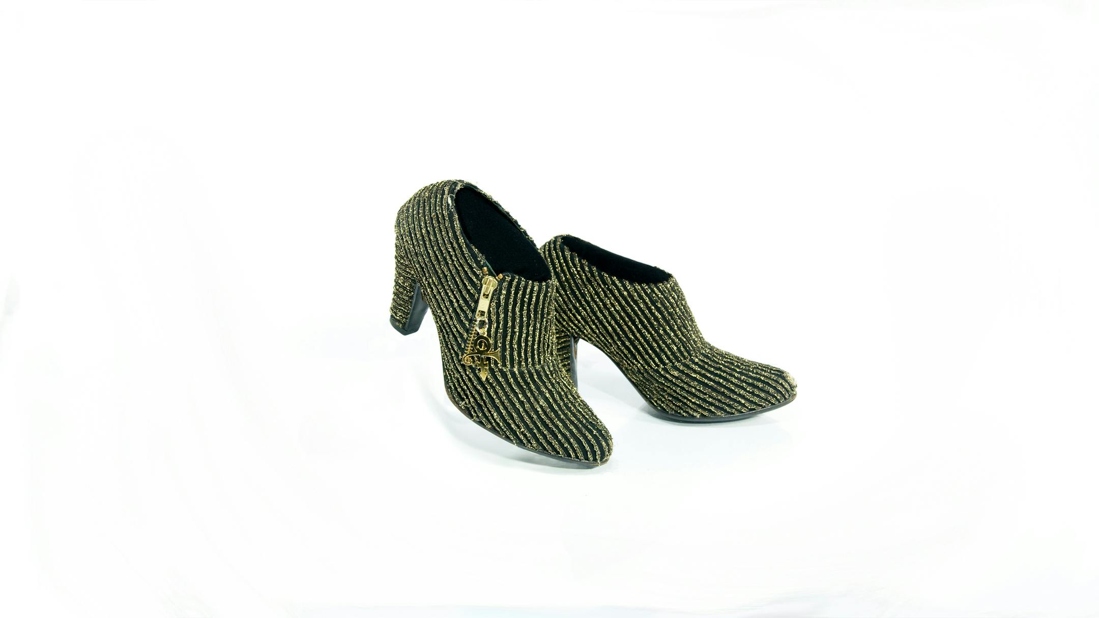 Prince wore these black shoes with gold lame stripes and Love Symbol #2 zipper pulls, along with a