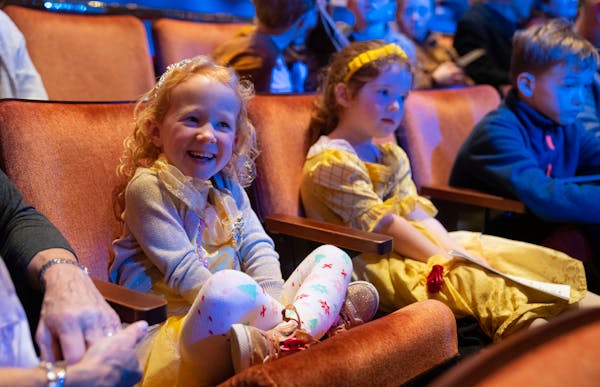 Monica Sunderman, 5, and Harriet Deering, 5, dressed as Belle before a performance of “Disney’s Beauty and the Beast” on Dec. 10 at the Ordway C