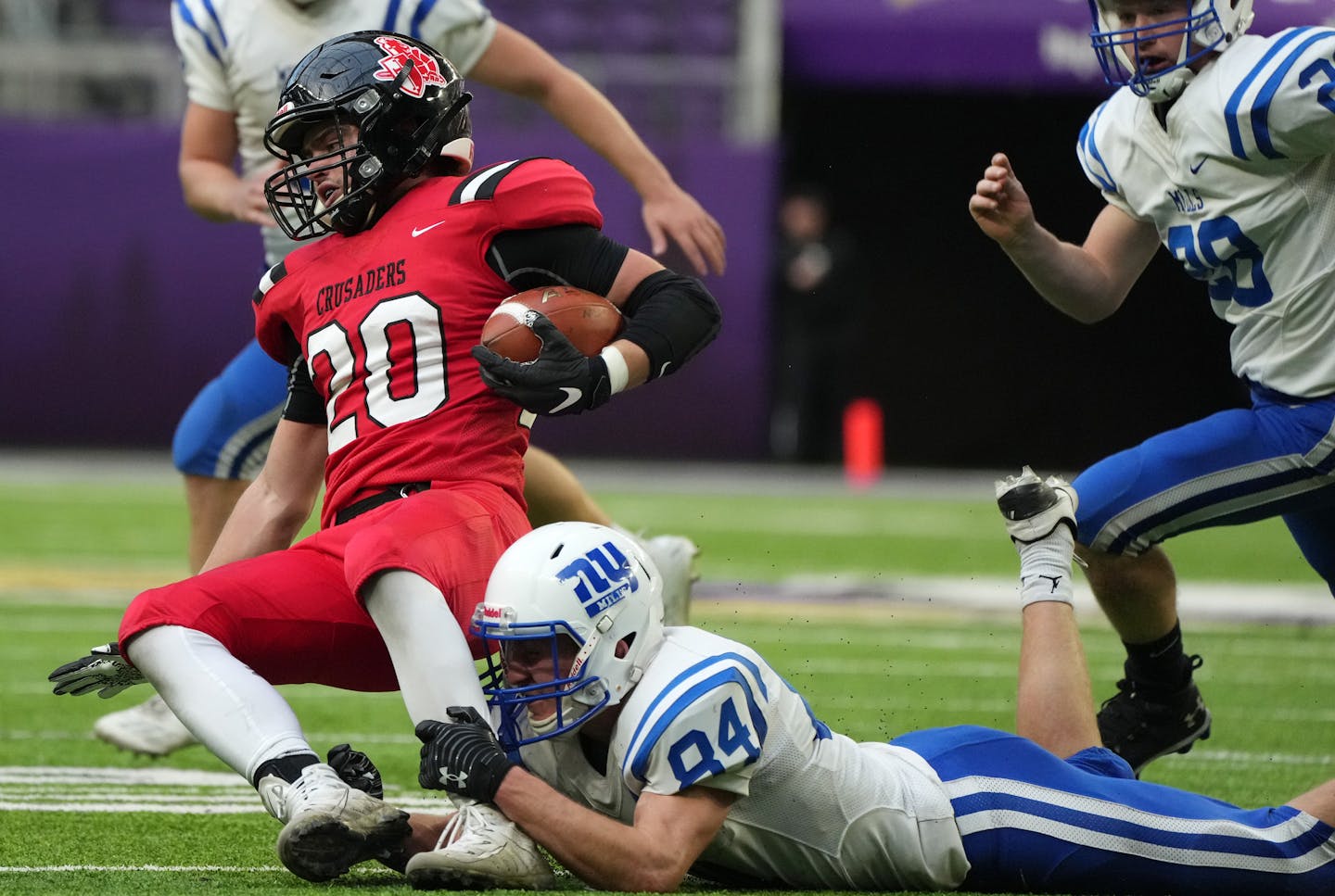 Mayer Lutheran's Samuel Dennis (20) was brought down by New York Mills' Jonah Johnson (84) in the second half as New York Mills played Mayer Lutheran in a Class 1A semifinal football game Saturday, Nov. 20, 2021 at U.S. Bank Stadium in Minneapolis. ] ANTHONY SOUFFLE • anthony.souffle@startribune.com