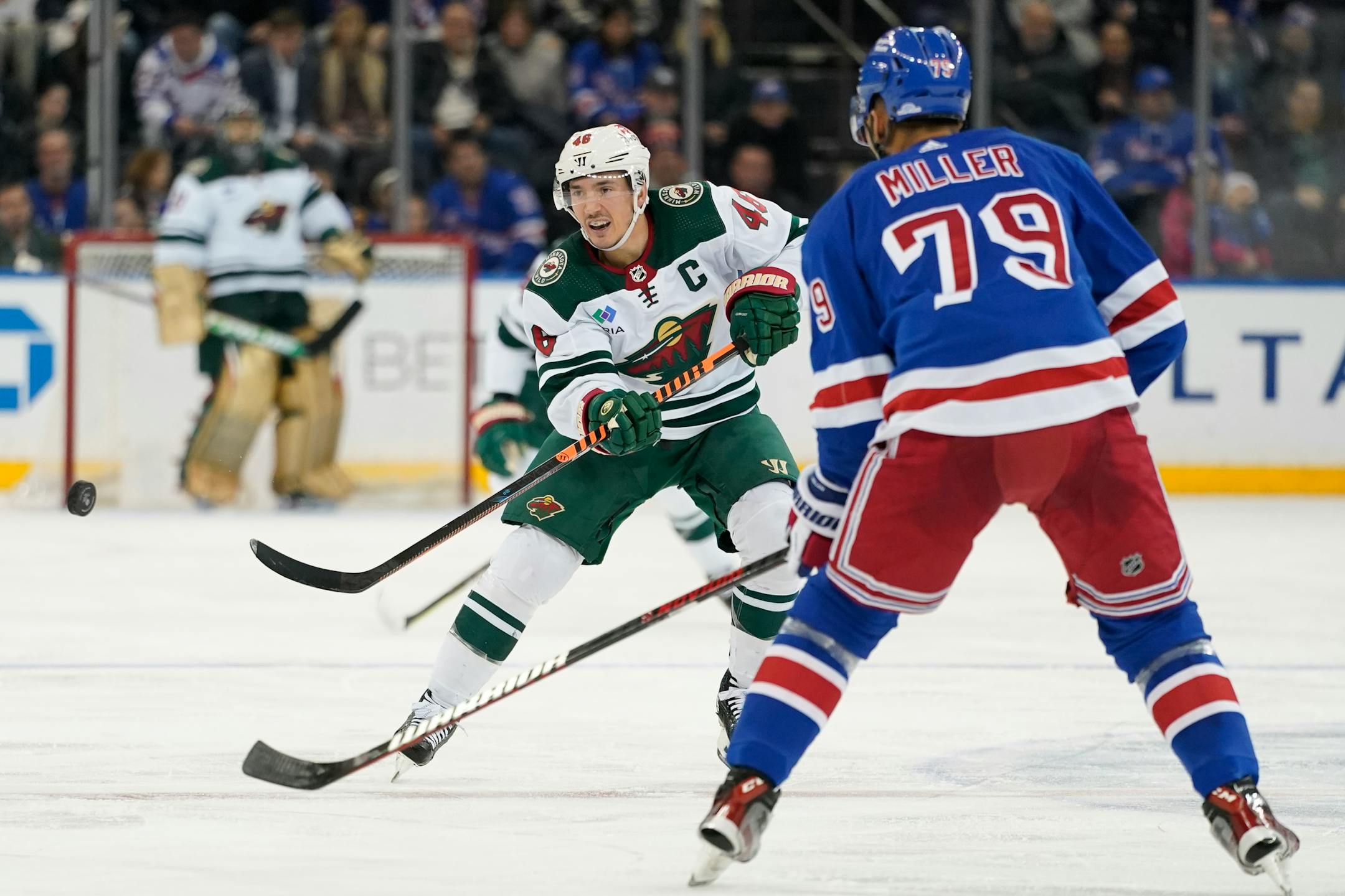 Minnesota Wild defenseman Jared Spurgeon (46) moves the puck around New York Rangers defenseman K'Andre Miller (79) during the third period of an NHL hockey game, Tuesday, Jan. 10, 2023, at Madison Square Garden in New York. The Rangers won 4-3. (AP Photo/Mary Altaffer)