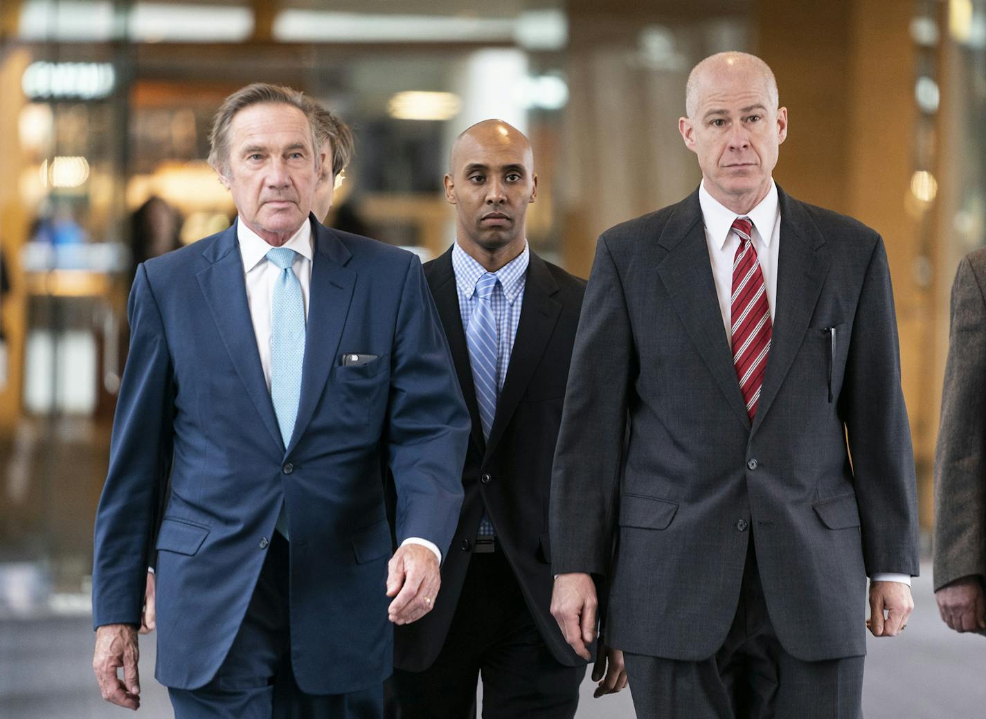 Former Minneapolis police officer Mohamed Noor, center, walks into the Hennepin County Courthouse for the verdict in the shooting death of Justine Ruszczyk Damond with his lawyers Peter Wold, left, and Thomas Plunkett, right, in Minneapolis on Tuesday, April 30, 2019. (Renee Jones Schneider/Minneapolis Star Tribune/TNS) ORG XMIT: 1310886