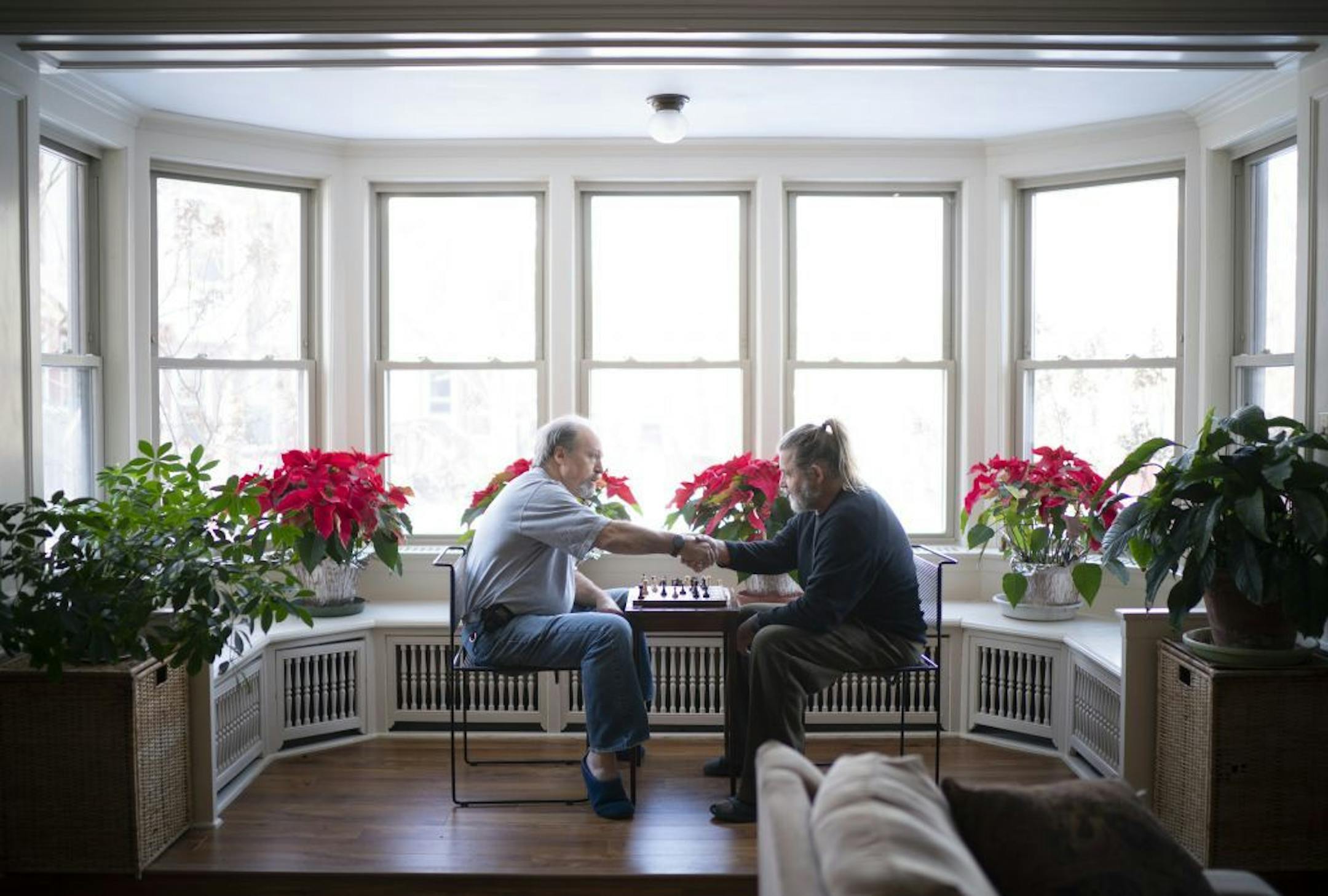 Max Tite, left, and Holley Weeks shook hands after Weeks won one of their daily games of chess. On this January afternoon they were playing in one of the common rooms in the Main House.