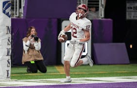 Maple Grove Crimson wide receiver Jacob Anderson (12) scores a touchdown in the first half. Rosemount Irish played the Maple Grove Crimson in the Clas