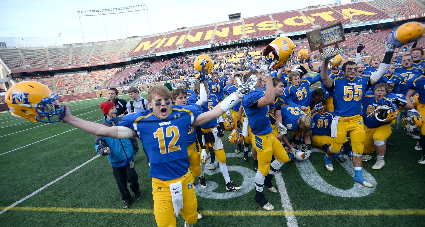 Minneota players, including quarterback Alex Pohlen (12), celebrated with their trophy after defeating Minneapolis North in the 1A championship game Saturday. ] (AARON LAVINSKY/STAR TRIBUNE) aaron.lavinsky@startribune.com Minneapolis North played Minneota in the Class 1A championship game on Saturday, Nov. 14, 2015 at TCF Bank Stadium.