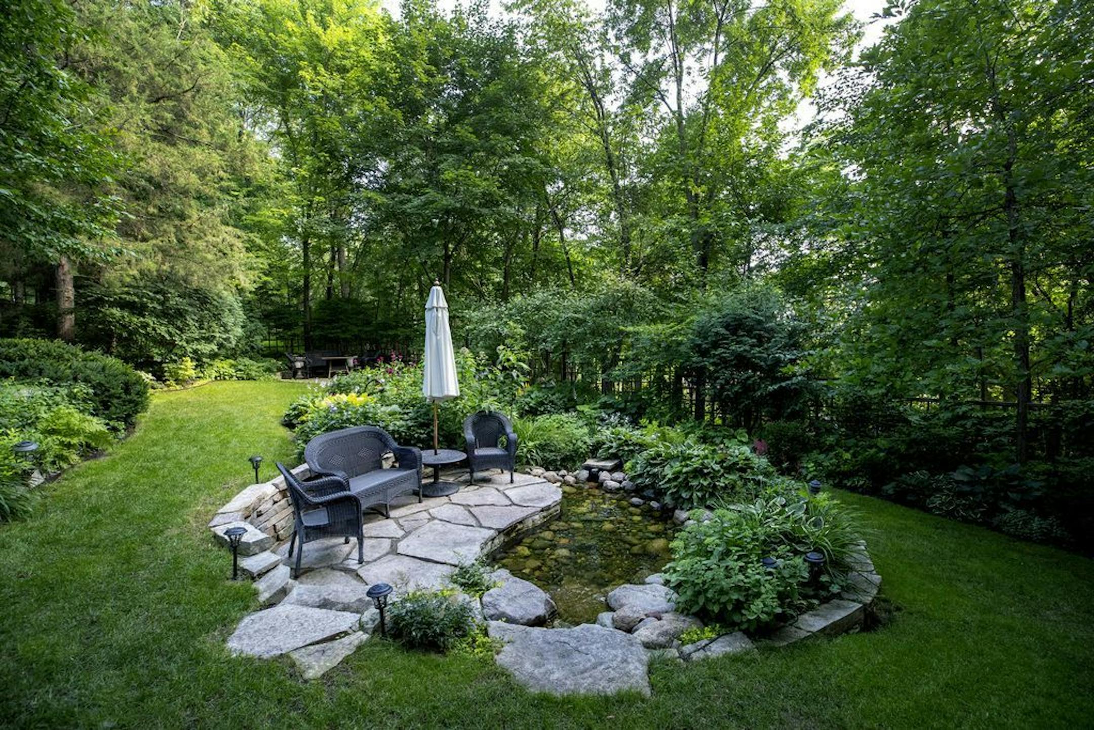 A stone patio within the garden.