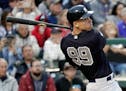 New York Yankees' Aaron Judge hits a triple to drive in two runs in fifth inning of a spring baseball exhibition game against the Atlanta Braves, Mond