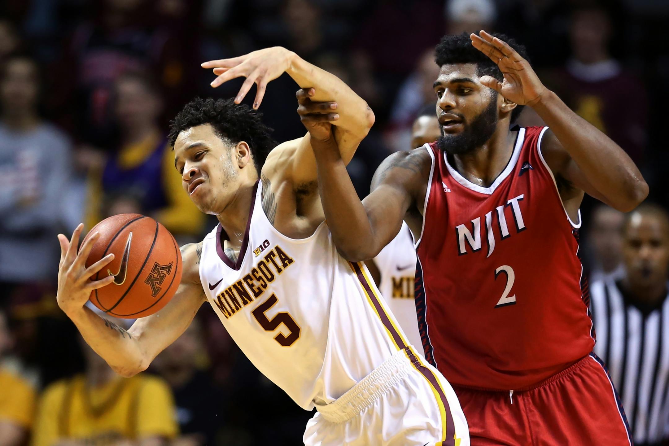 Minnesota Golden Gophers guard Amir Coffey (5) keep the ball away from N.J.I.T Highlanders guard Tim Coleman (2) at Williams Arena December 06,2016 in Minneapolis , MN.