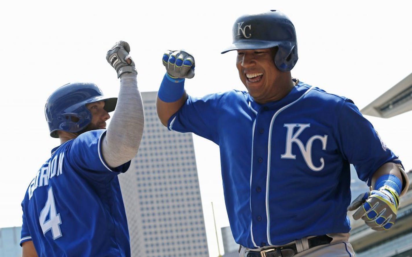 Kansas City Royals' Salvador Perez, right, celebrates his three-run home run off Minnesota Twins pitcher Lance Lynn with Alex Gordon in the first inning of a baseball game Wednesday, July 11, 2018, in Minneapolis.