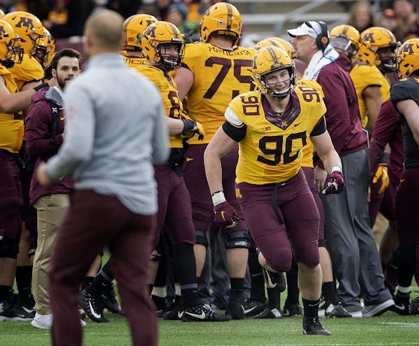 Sam Renner (90) ran to Gophers head coach P.J. Fleck after learning he won a scholarship during the spring game. ] CARLOS GONZALEZ &#x2022; cgonzalez@
