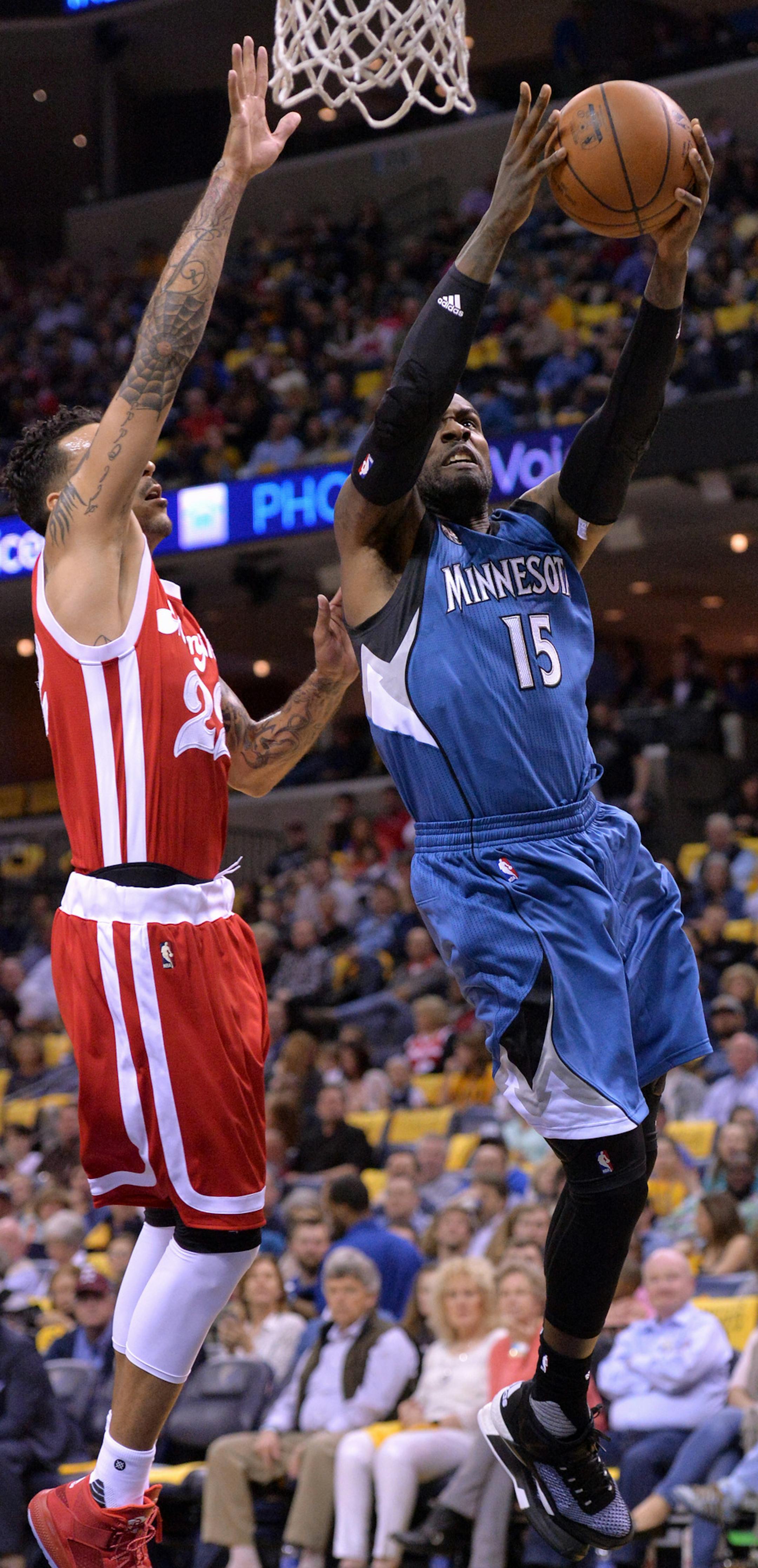 Minnesota Timberwolves forward Shabazz Muhammad (15) shoots against Memphis Grizzlies forward Matt Barnes (22) during the first half of an NBA basketball game Friday, Feb. 19, 2016, in Memphis, Tenn. (AP Photo/Brandon Dill)