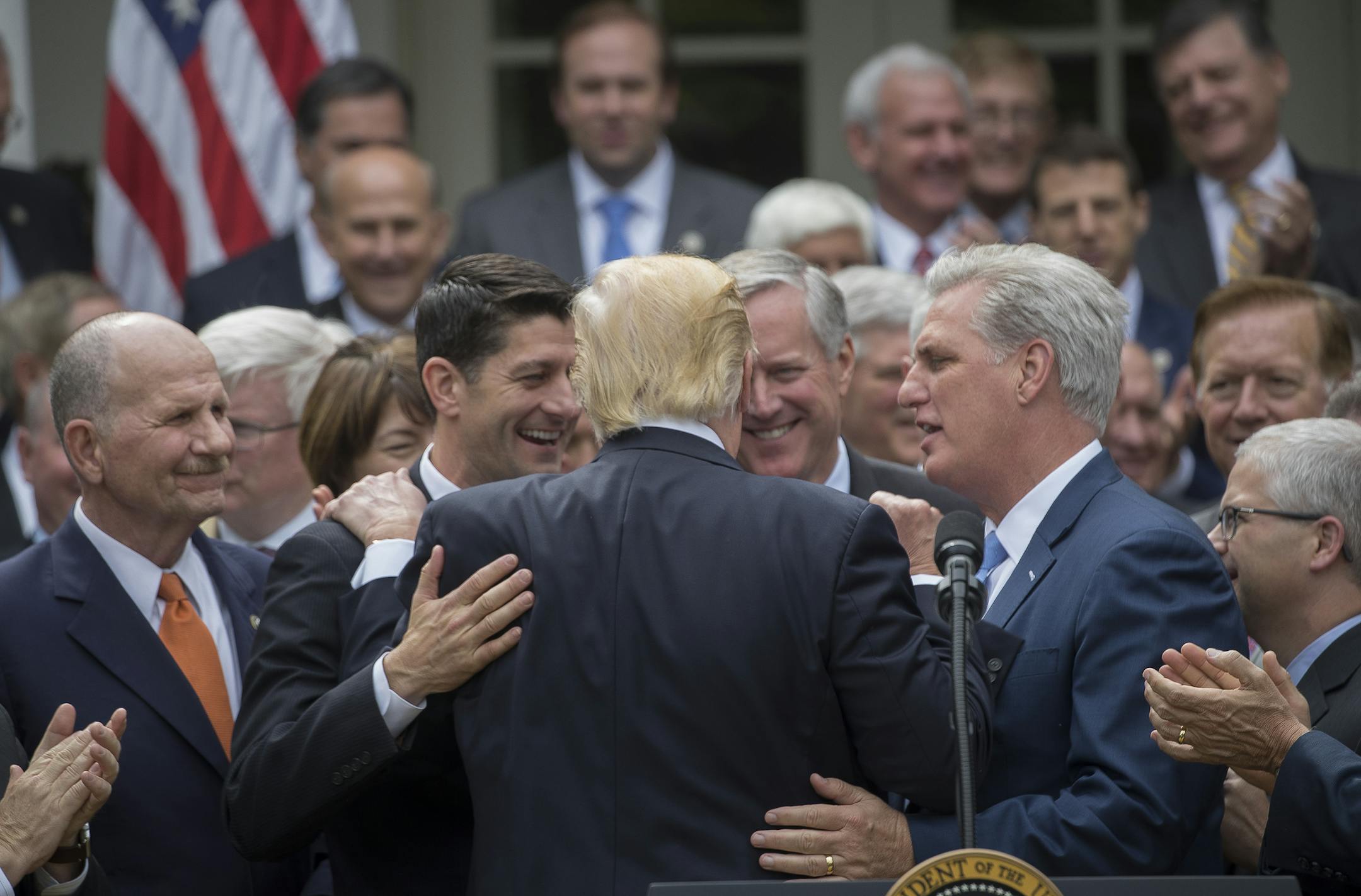 President Donald Trump is embraced by House Republican leaders as they came to the White House to celebrate the passage of the American Health Care Act, in Washington, May 4, 2017. The bill faces a more uncertain future in the Senate. From left: House Speaker Paul Ryan (R-Wis.); Trump; Rep. Mark Meadows (R-N.C.), who heads the Freedom Caucus; and House Majority Leader Kevin McCarthy (R-Calif.). (Stephen Crowley/The New York Times)