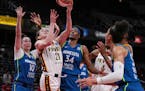 Indiana Fever forward Emily Engstler shoots the ball against Lynx forward Jessica Shepard (10) and center Sylvia Fowles (34) during Tuesday's game