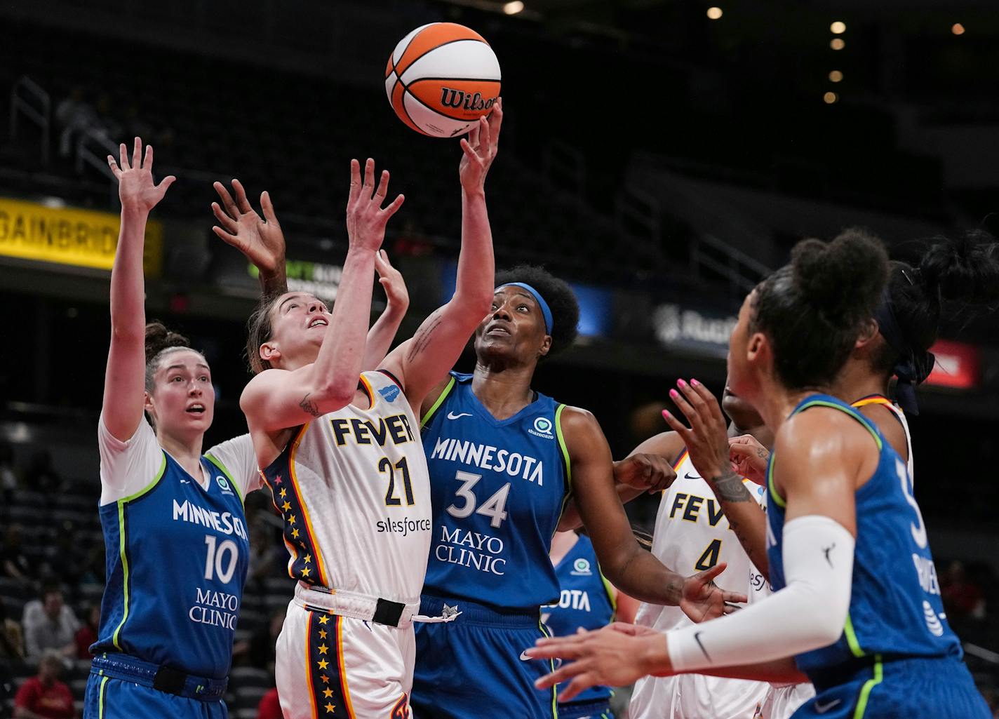 Indiana Fever forward Emily Engstler shoots the ball against Lynx forward Jessica Shepard (10) and center Sylvia Fowles (34) during Tuesday's game