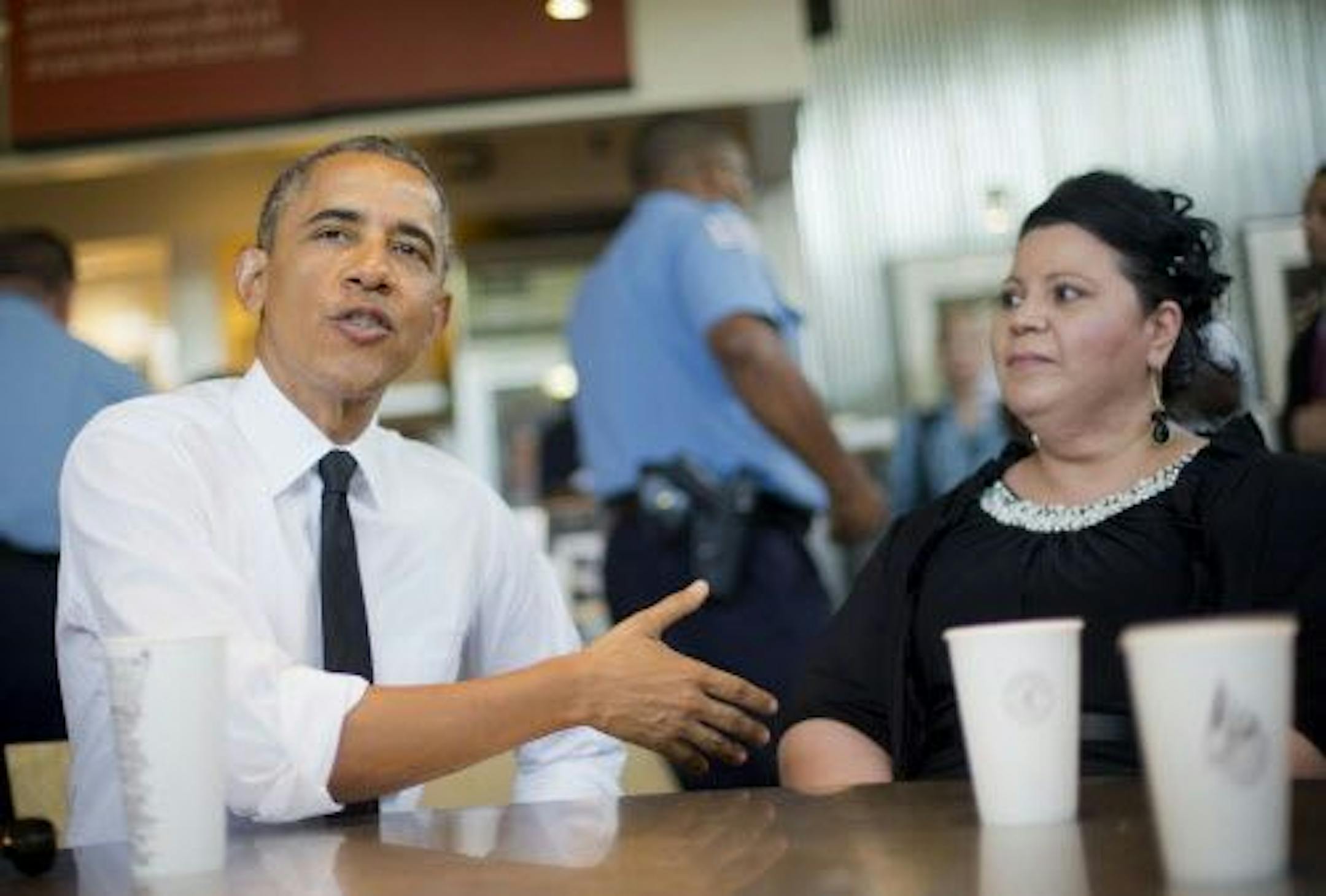 President Barack Obama sits down to have lunch with Shelby Ramirez at a Chipotle Mexican Grill in Washington, Monday, June 23, 2014, before attending the White House Summit on Working Families.