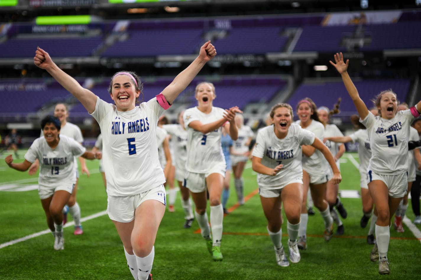 Holy Angels players, including Madden Smith (6), celebrate their shootout victory against Mahtomedi during the girls' Class 2A soccer state championship game Friday, Nov. 4, 2022 at U.S. Bank Stadium in Minneapolis, Minn.. ] AARON LAVINSKY • aaron.lavinsky@startribune.com