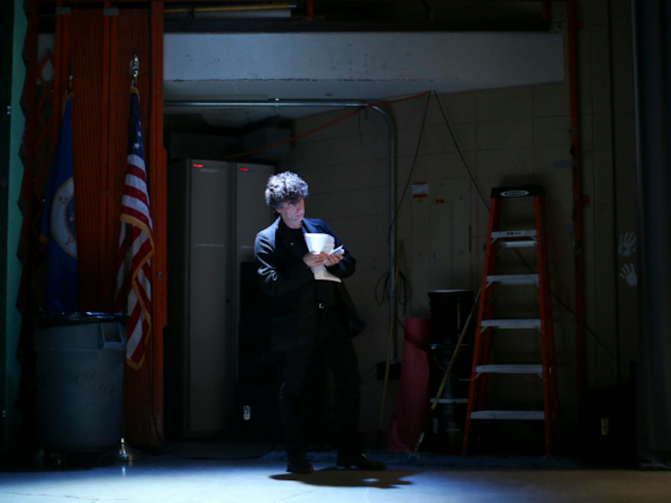 Neil Gaiman looked over submitted questions before his appearance Monday night. Star Tribune photo by Jeff Wheeler