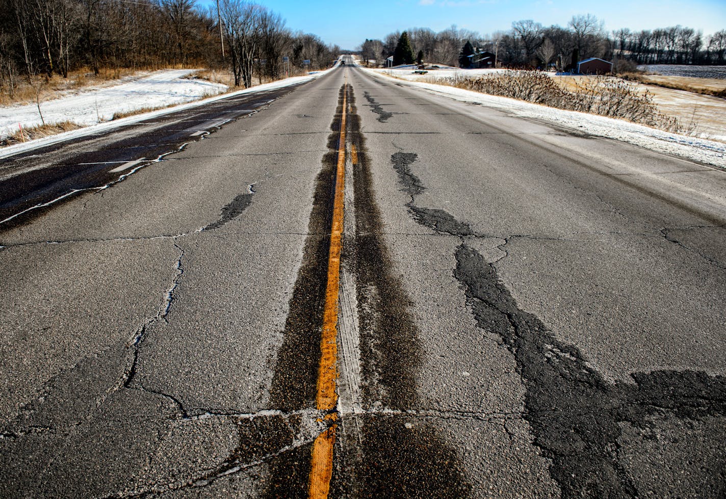 A bumpy ride: Across Minnesota, stopgap measures patch together pockmarked roads like this one.