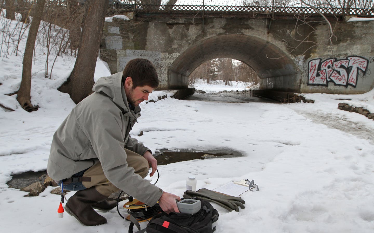 Zach Granata, Water Quality Assistant, Minnehaha Creek Watershed District, took water readings from Minnehaha Creek near East 47th Street and South 28th Ave. What's safe on sidewalks and roadways is a menace to creeks and lakes. A team of researchers poked holes into ice-covered Minnehaha Creek on 2/27/13 to test how salty the underlying water is. The source is brine in runoff that drains into the creek from roads, and it's not healthy for the stream's plants and critters.] Bruce Bisping/Star Tr