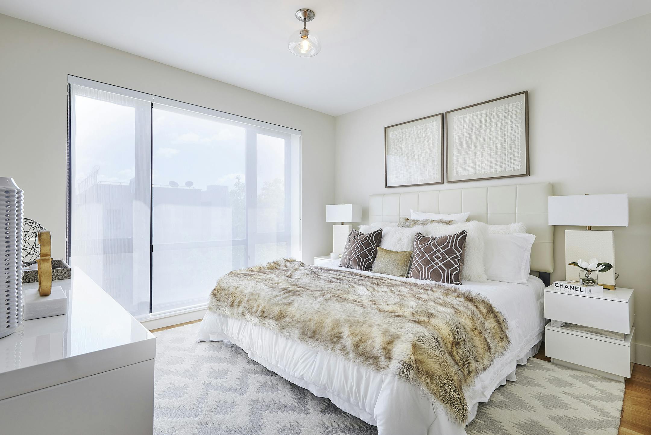 Soft colors including various shades of white and cream help make this master bedroom soothing and inviting.