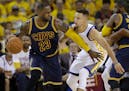 In this June 2, 2016, file photo, LeBron James dribbles against State Stephen Curry during the first half of Game 1 of basketball's NBA Finals
