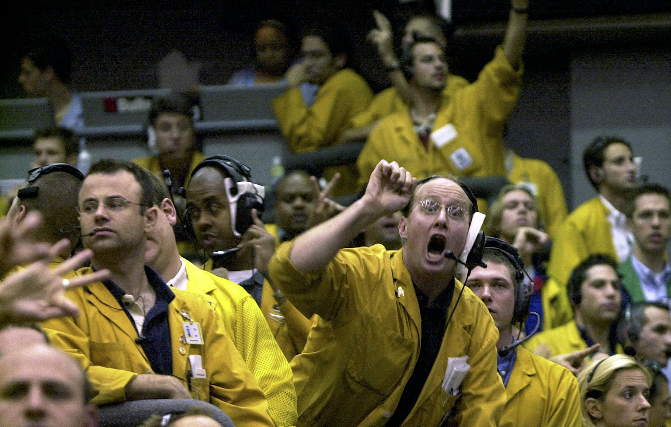 FILE - In this Sept. 16, 2003 file photo, clerks shout in the Euro Dollar Futures pit at the Chicago Mercantile Exchange. Most pits in Chicago and New York where traders bet on future prices of palladium and gold, cattle and corn and dozens of other commodities are expected to close for good on Monday, July 6, 2015. (AP Photo/Anne Ryan, File)