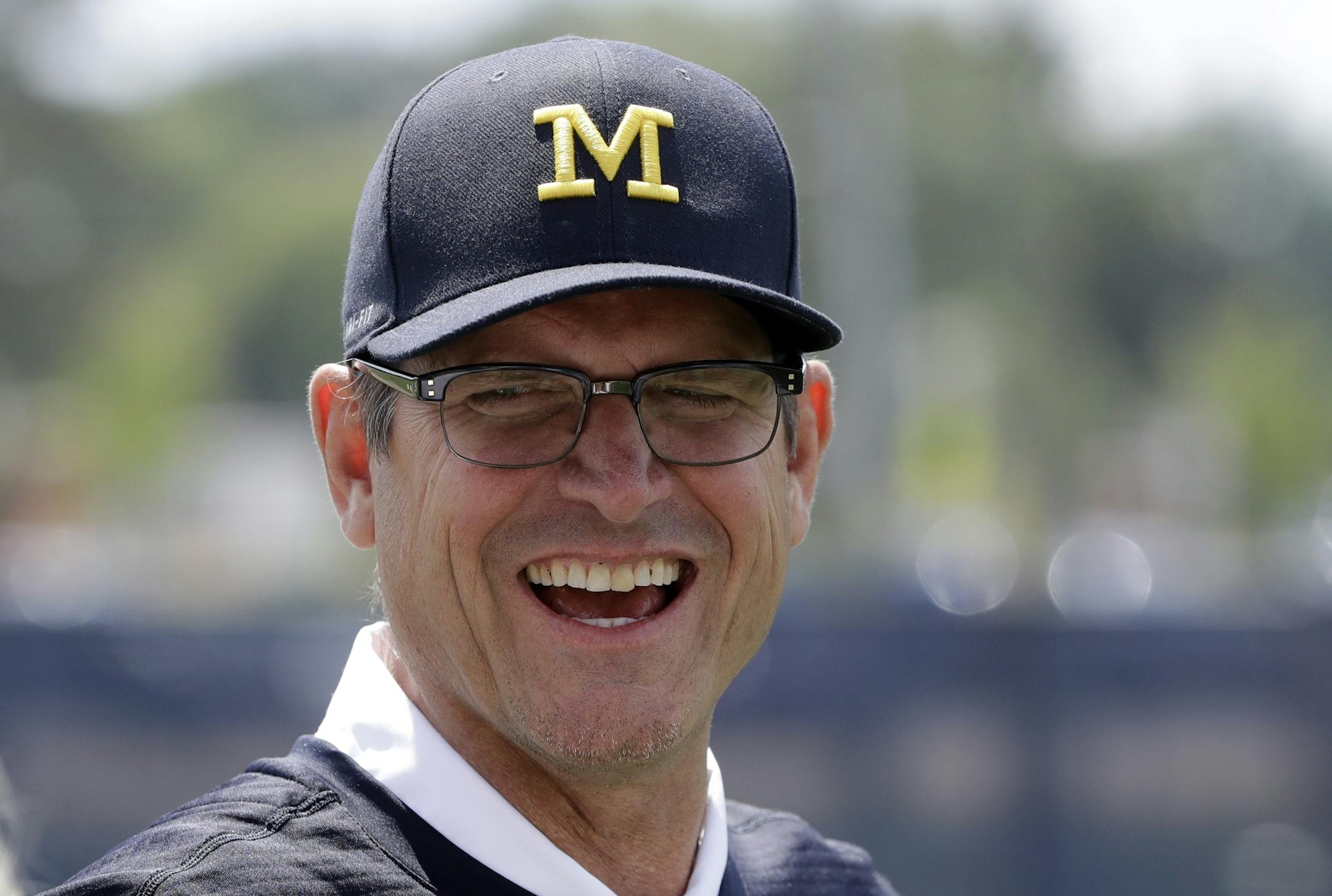 Michigan football coach Jim Harbaugh is seen, Monday, July 17, 2017, in Ann Arbor, Mich. (AP Photo/Carlos Osorio)