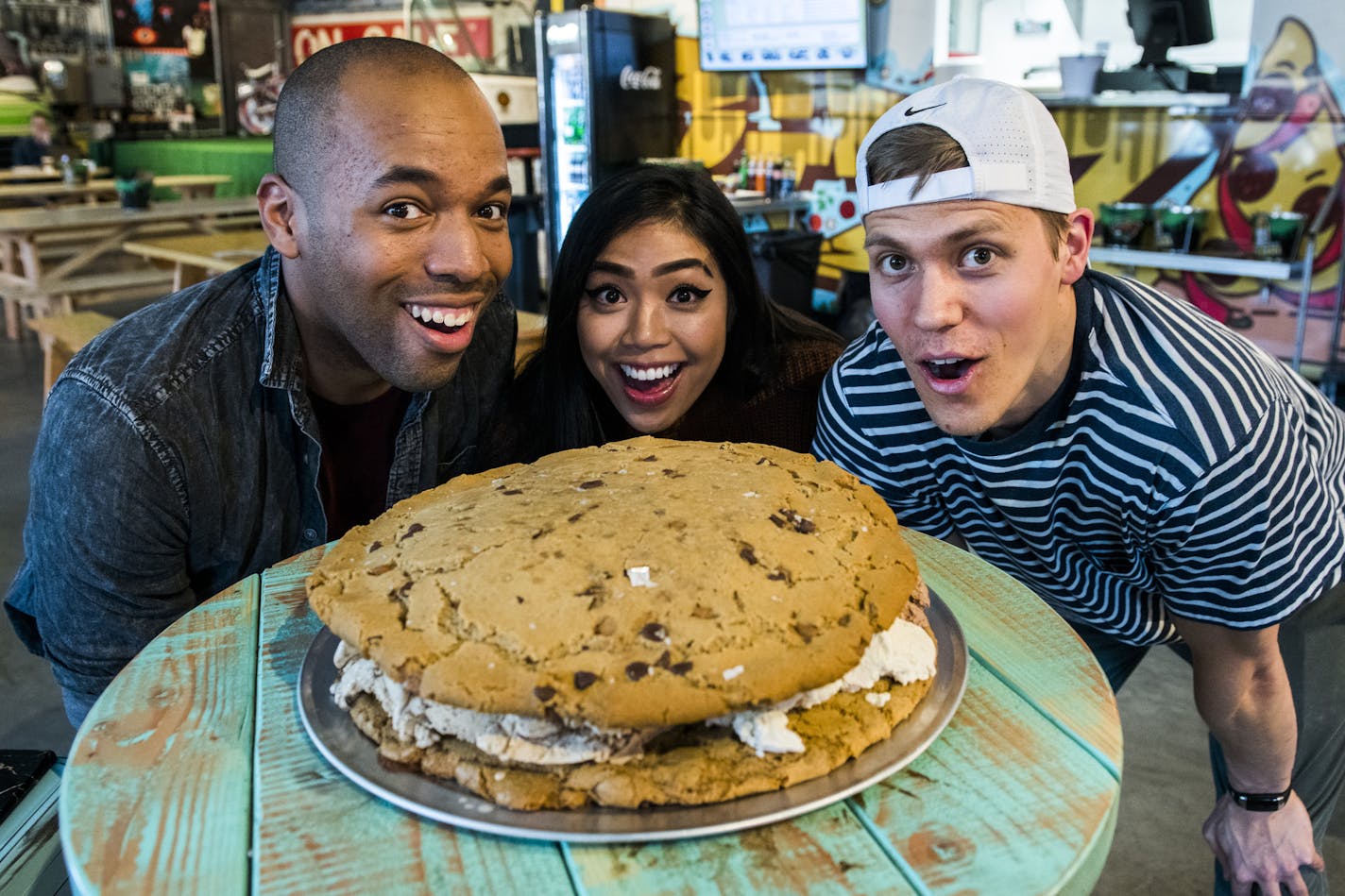 Local Instagram foodies (left to right) Lamar Roberts, Nikki Miraflor and Zach Vraa dig into the 15-pound ice cream sandwich. ] MARK VANCLEAVE &#xef; mark.vancleave@startribune.com * This giant treat sandwiches five flavors of Sebastian Joe's ice cream between two T-Rex cookies. The completed sandwich weighs 15 lbs. Photographed Oct. 20, 2017 at the new Seventh Street Truck Park in St. Paul.