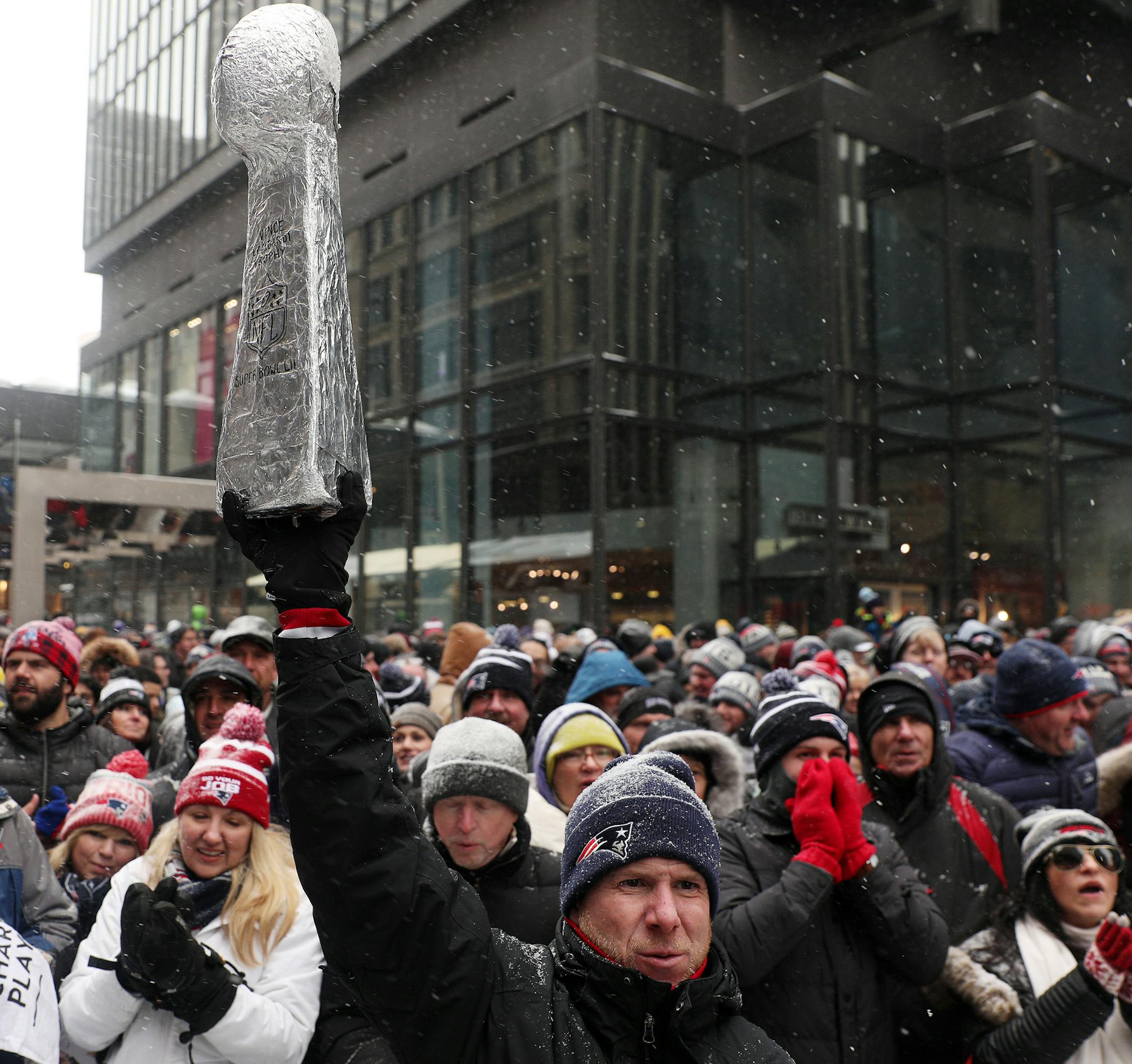 Jeff Guinee of Boston held up an aluminum foil replica of the Vince Lombardi Trophy during the Patriots rally Saturday on Nicollet Mall.