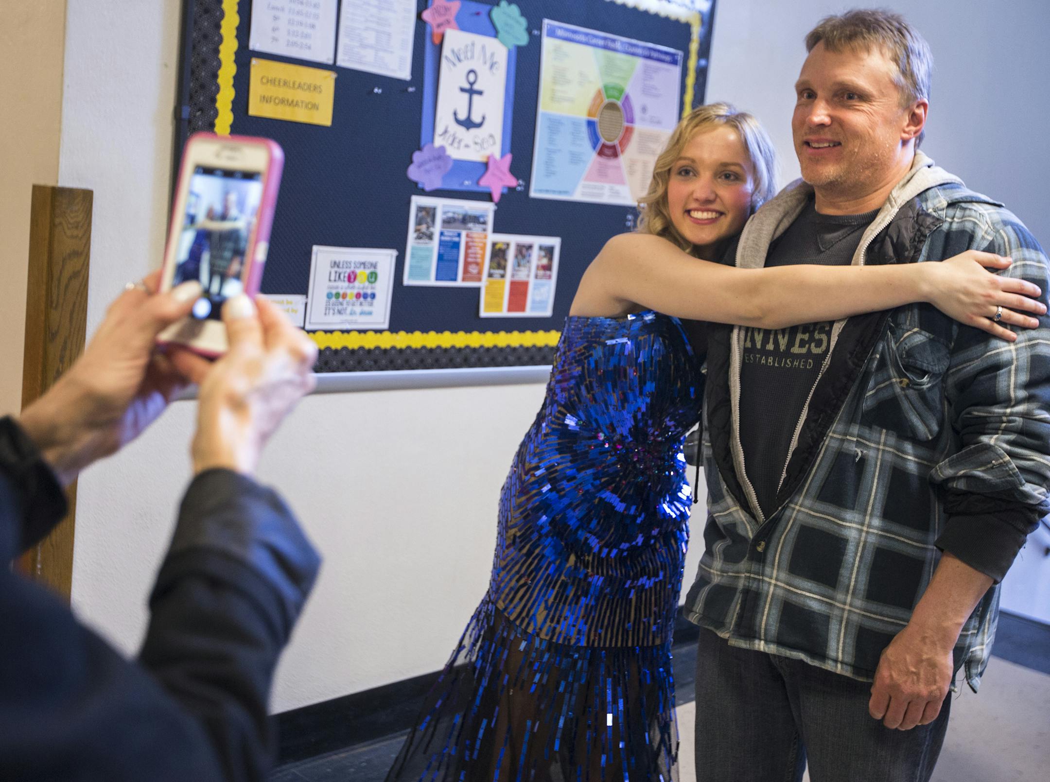 Allie Hill poses for a photo with her dad Scott Hill before prom. ] (Leila Navidi/Star Tribune) leila.navidi@startribune.com BACKGROUND INFORMATION: Allie Hill, who's dad Scott Hill works at U.S. Steel's Minntac taconite pellet plant as an electrician, plans to go to Mesabi Range College on scholarships to study conservation or forestry. The Eveleth-Gilbert High School prom grand march on Saturday, April 30, 2016 in Eveleth. When the mines go down on the Iron Range, everything else seems to foll